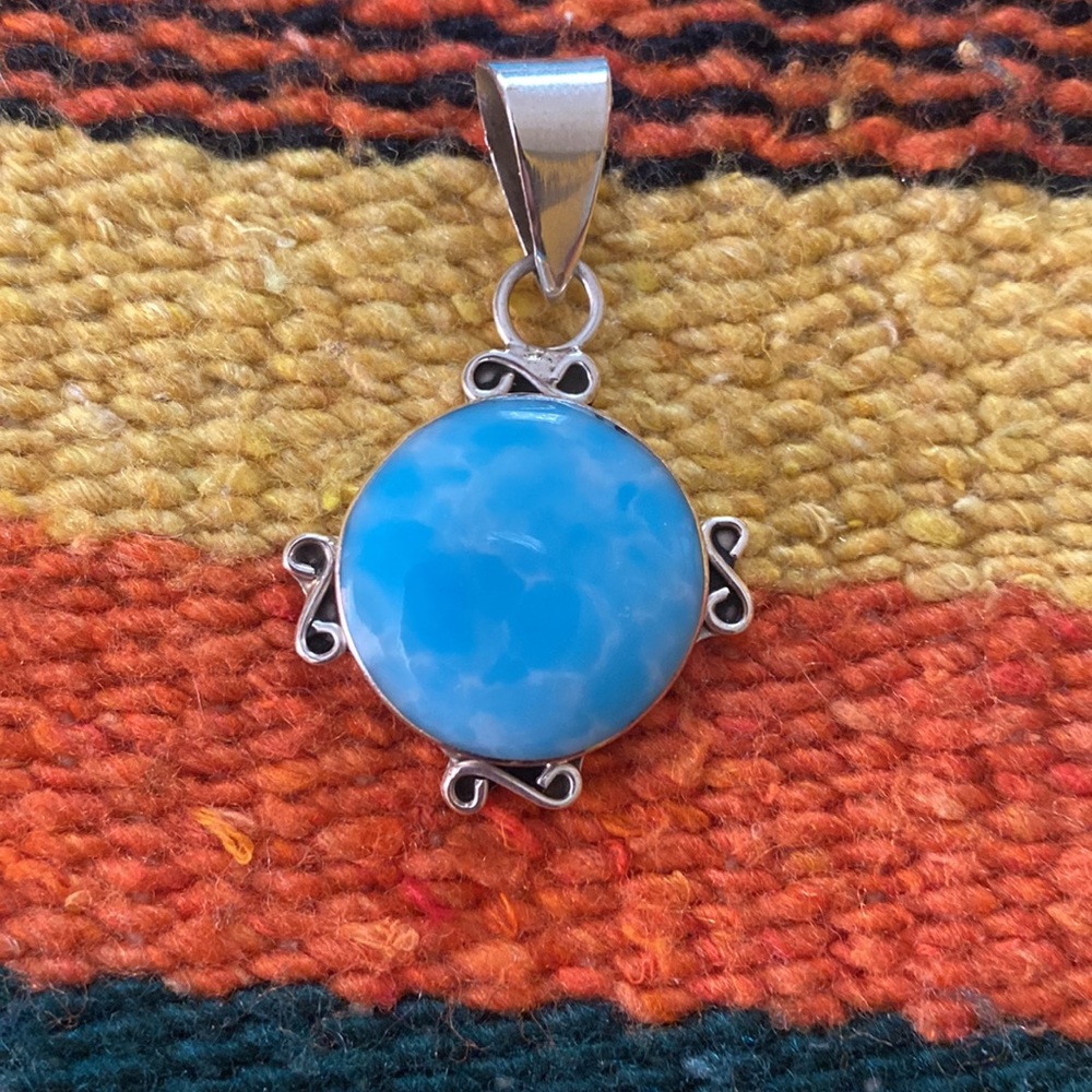 A beautiful turquoise and sterling silver southwest style pendant